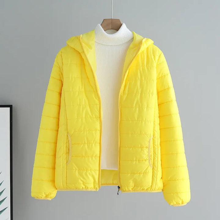Women's black quilted transitional jacket with hood & pockets, perfect for spring & fall.