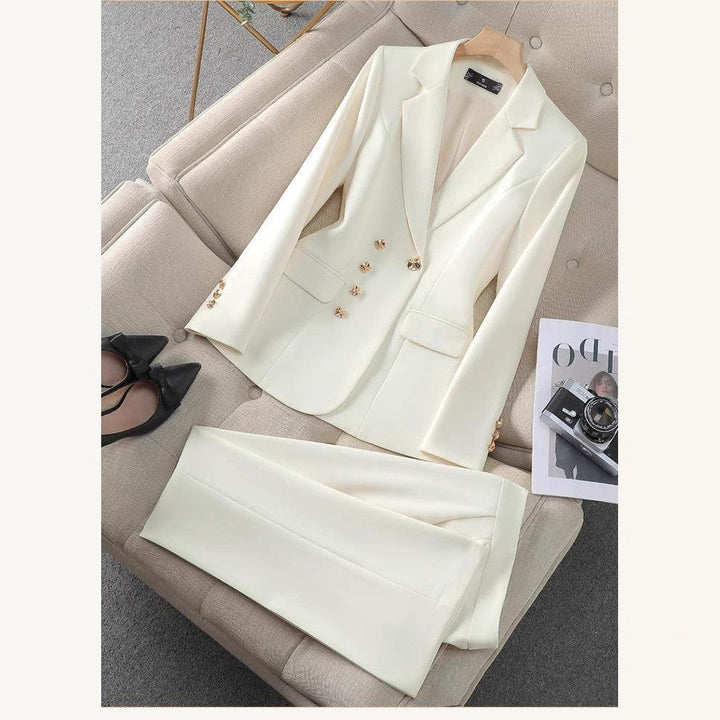 Elegant white women's pantsuit with a tailored blazer and golden buttons, perfect for professional business wear.