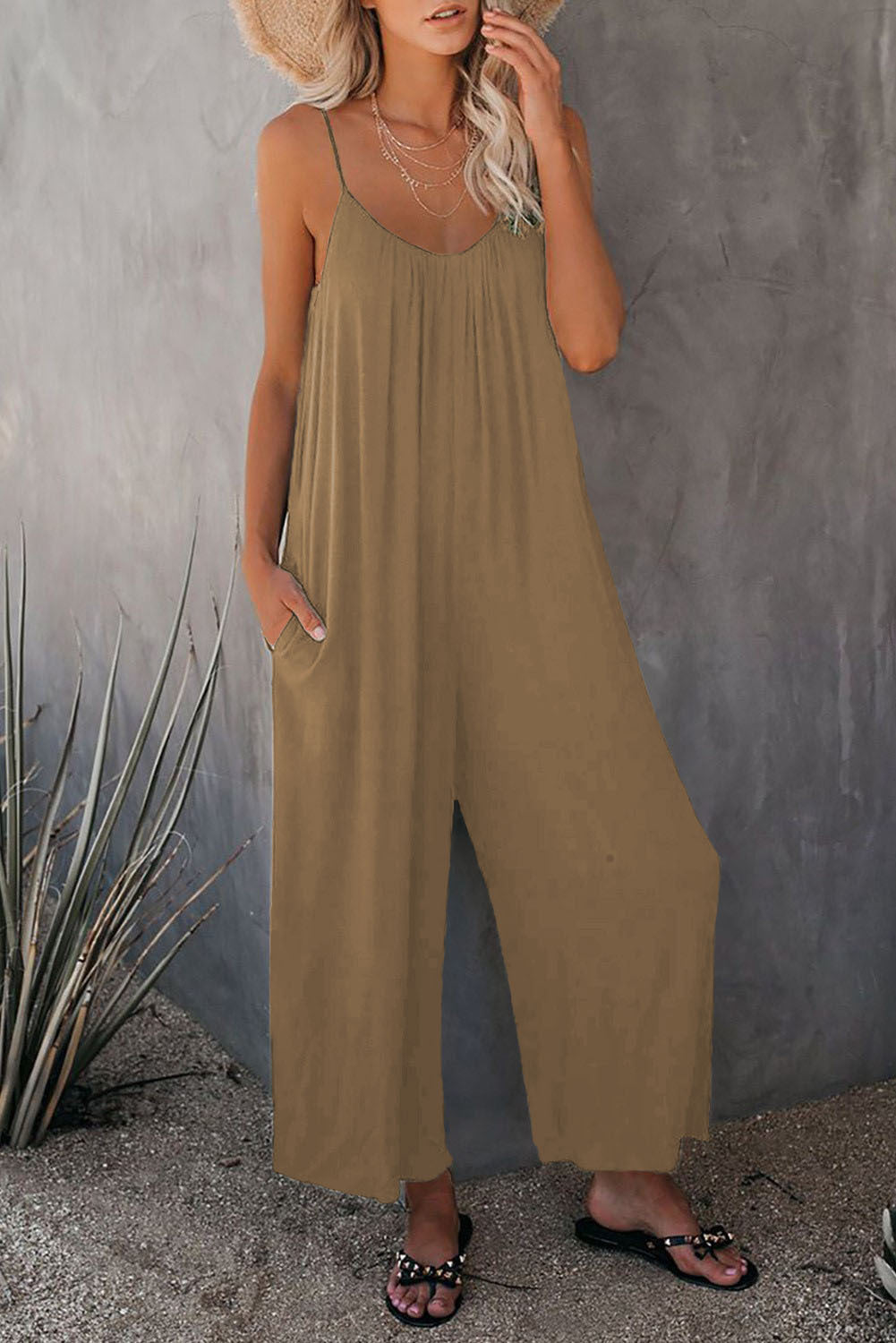 Women's casual day jumpsuit, sleeveless with plunging neckline & pockets, perfect for warm summer outings.