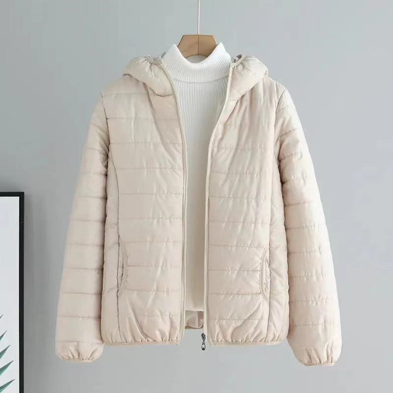 Close-up of the quilted pattern on a women's transitional jacket in a dark color.