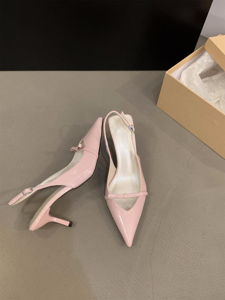 Classic black women's slingback pumps, elegant pointed toe, fine strap. Essential for formal & office wear.