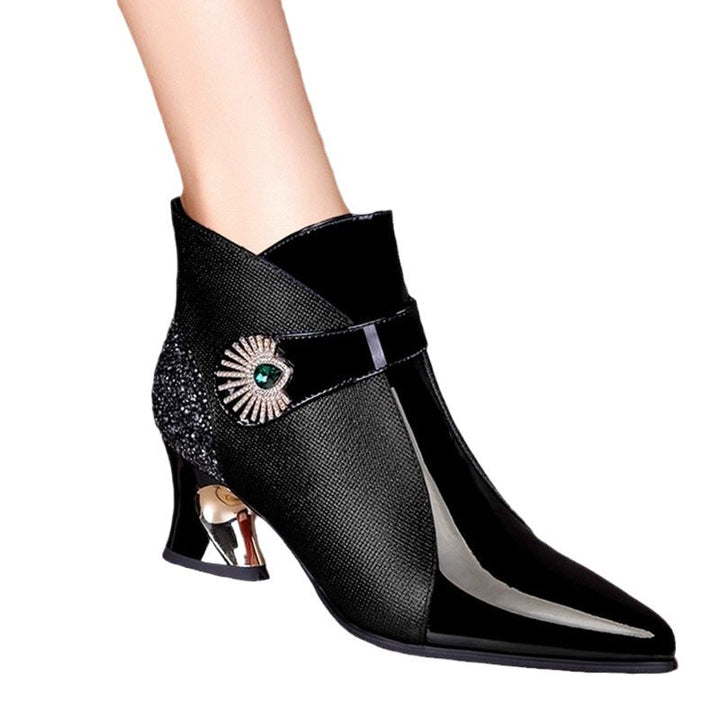Close-up of sparkling women's ankle boots, showcasing glitter detail & elegant design, ideal for evening.