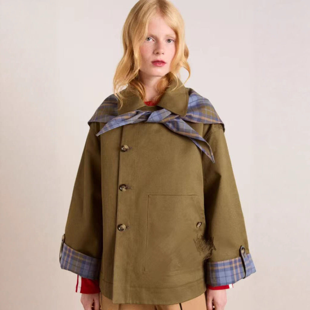 Women's chic brown trench coat with a distinctive collar and practical pockets, perfect for fall or spring.