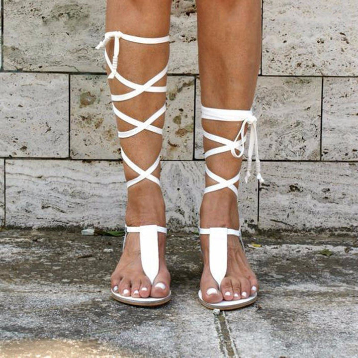 Black women's strappy gladiator sandals for stylish summer casual wear. Flat, open-toe design with adjustable straps.
