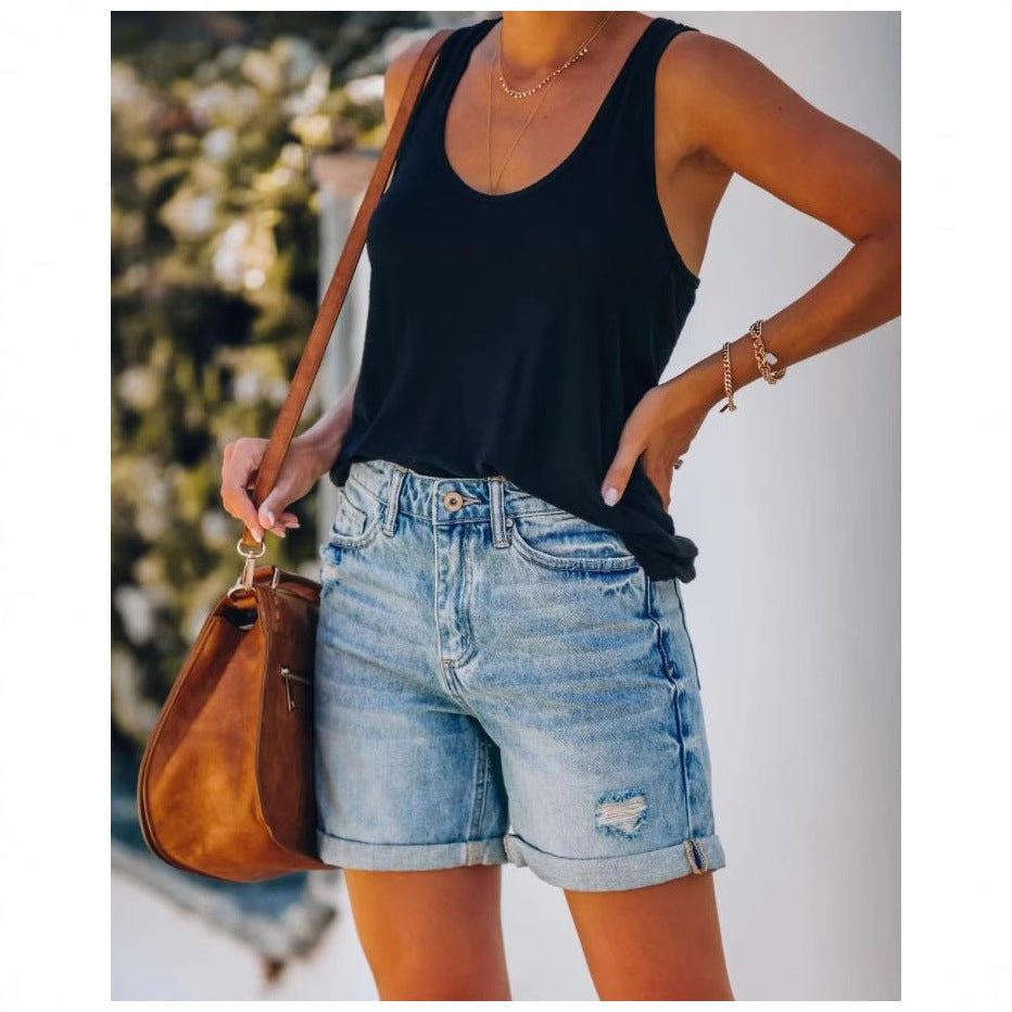 Versatile light blue distressed denim shorts for women, with a chic rolled hem, ideal for warm weather.