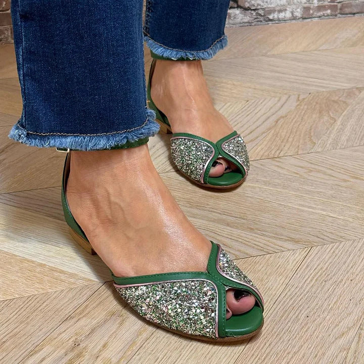 Chic green flat sandals for women, featuring a comfortable design and secure ankle strap for summer.