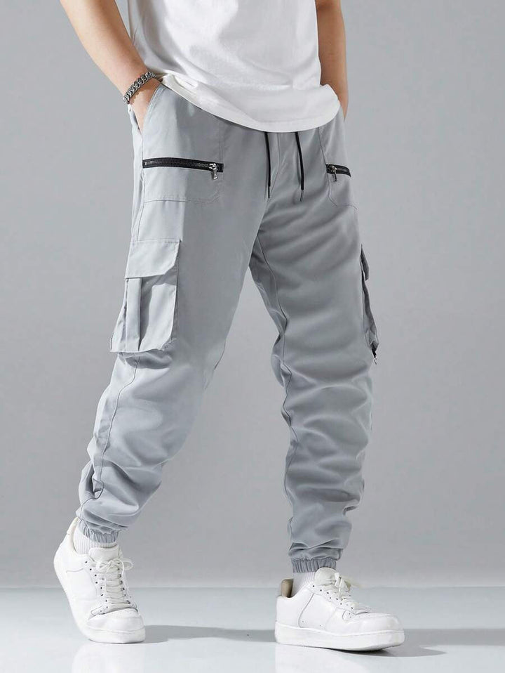 Modern men's urban cargo pants, combining street style with practical utility pockets & comfortable fit.