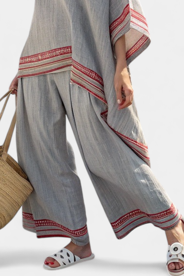 Stylish women's asymmetrical blouse in red stripe, paired with flowing wide-leg pants for an elegant ethnic set.