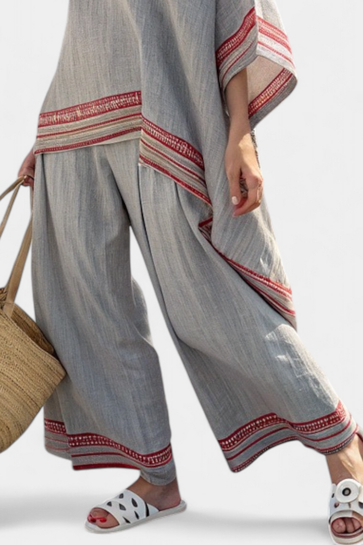 Stylish women's asymmetrical blouse in red stripe, paired with flowing wide-leg pants for an elegant ethnic set.