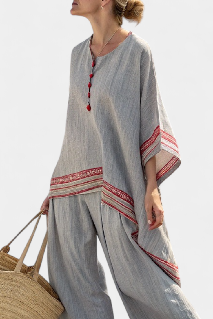 Sophisticated two-piece women's set with ethnic embroidered wide-leg pants and an asymmetrical red stripe top.