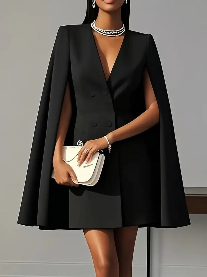 Women's stylish blazer dress with a flowing cape. Sophisticated for office wear or evening events.
