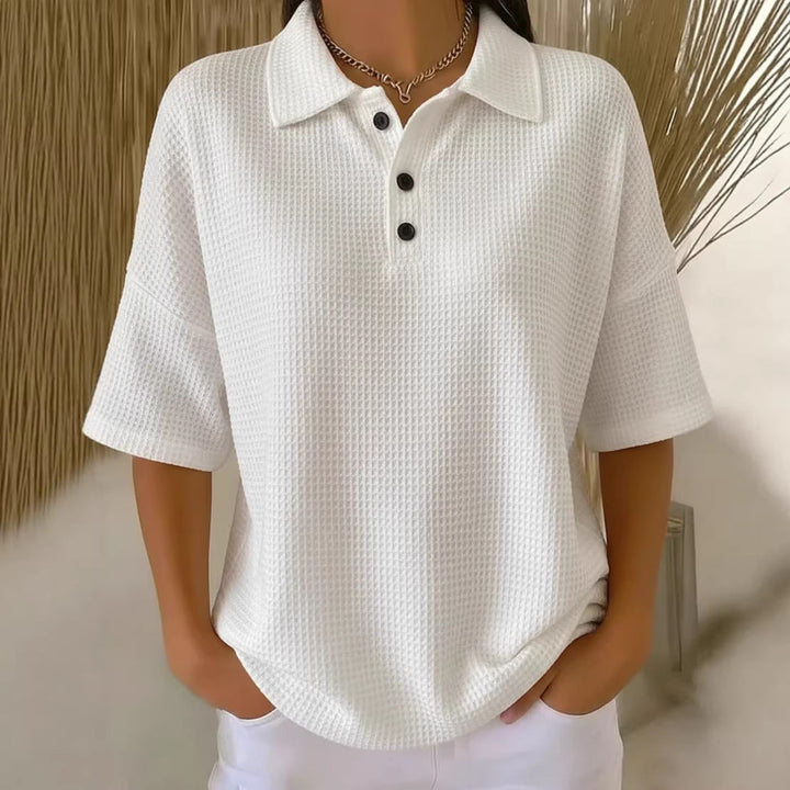 Relaxed fit women's short sleeve polo with button placket, perfect for leisure wear & spring fashion.