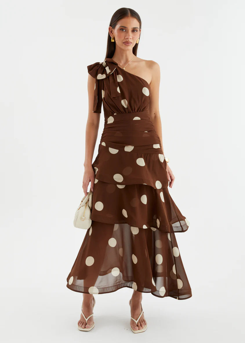 Women's polka dot asymmetrical one-shoulder maxi dress with a voluminous skirt, ideal for formal events.