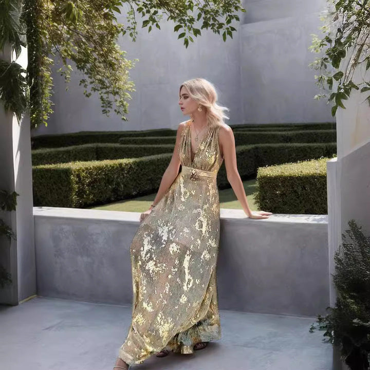 Womens elegant long maxi dress with a sophisticated gold pattern and deep V-neck, perfect party wear.