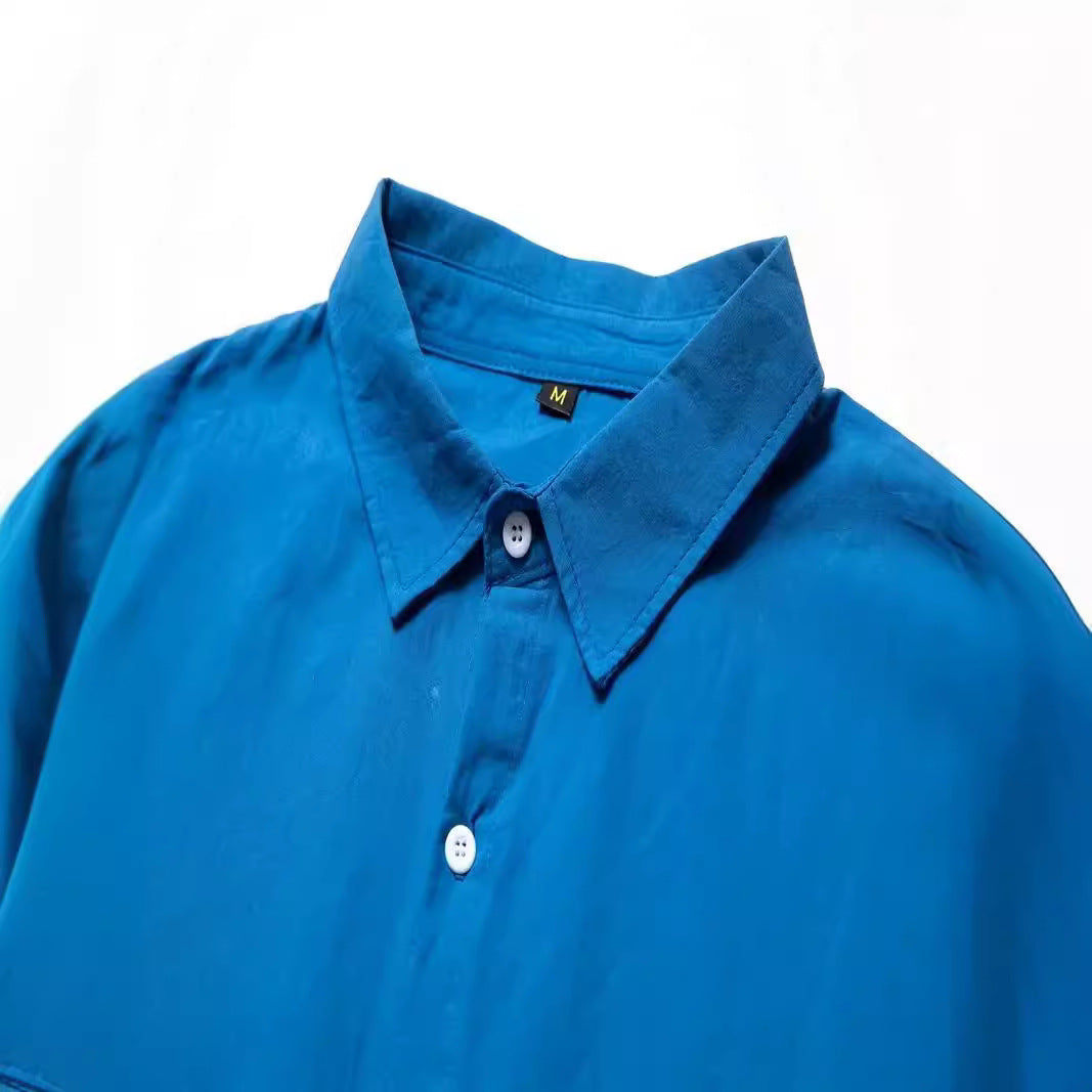 Close-up: Men's lightweight casual button-down shirt fabric texture. Soft, breathable summer style.