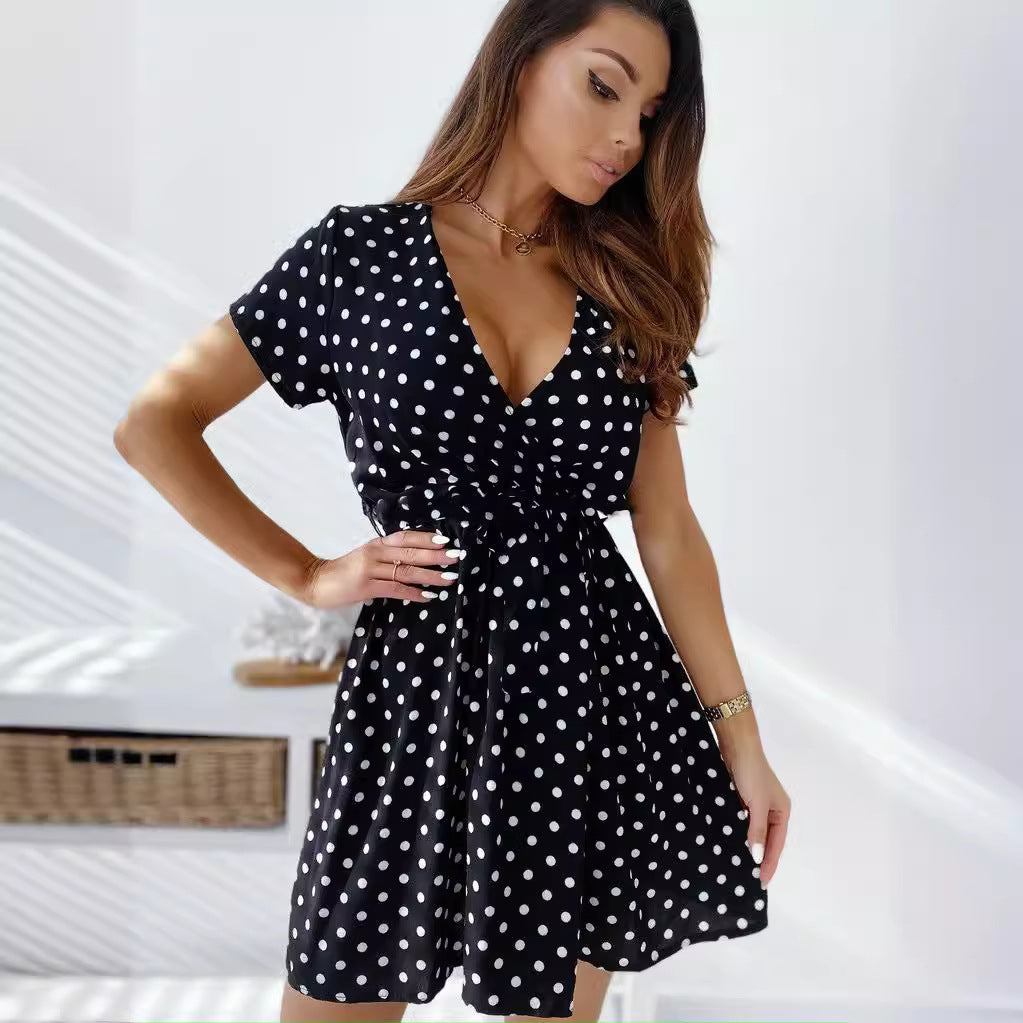 Lightweight women's polka dot mini wrap dress, stylish and comfortable for summer days, with a playful short sleeve design.