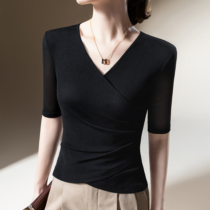 Woman modeling a stylish V-neck wrap top with half sleeves. Elegant draping provides a flattering, sophisticated look.