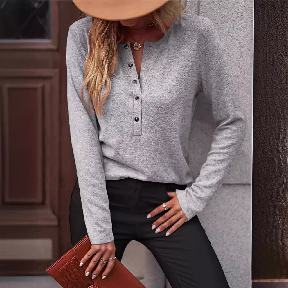 Relaxed fit women's long sleeve top, comfortable and versatile, featuring elegant button accents.