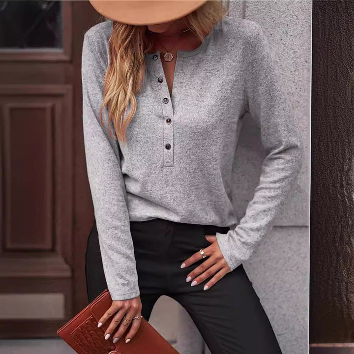 Relaxed fit women's long sleeve top, comfortable and versatile, featuring elegant button accents.