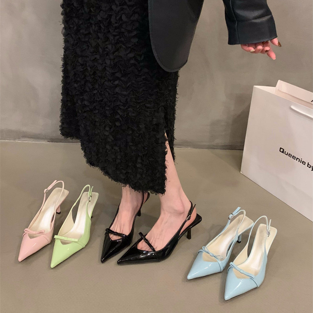 Elegant women's black slingback pumps with a fine strap & pointed toe, ideal for formal events & office wear.