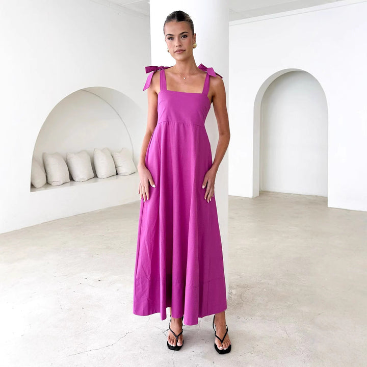 Versatile women's red maxi dress featuring adjustable spaghetti straps & a flattering silhouette.