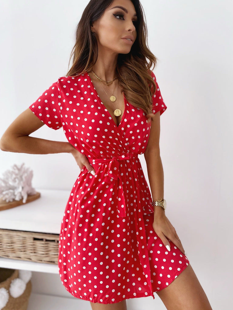 Chic women's polka dot mini wrap dress with a flattering V-neck and stylish short sleeves, great for summer fashion.