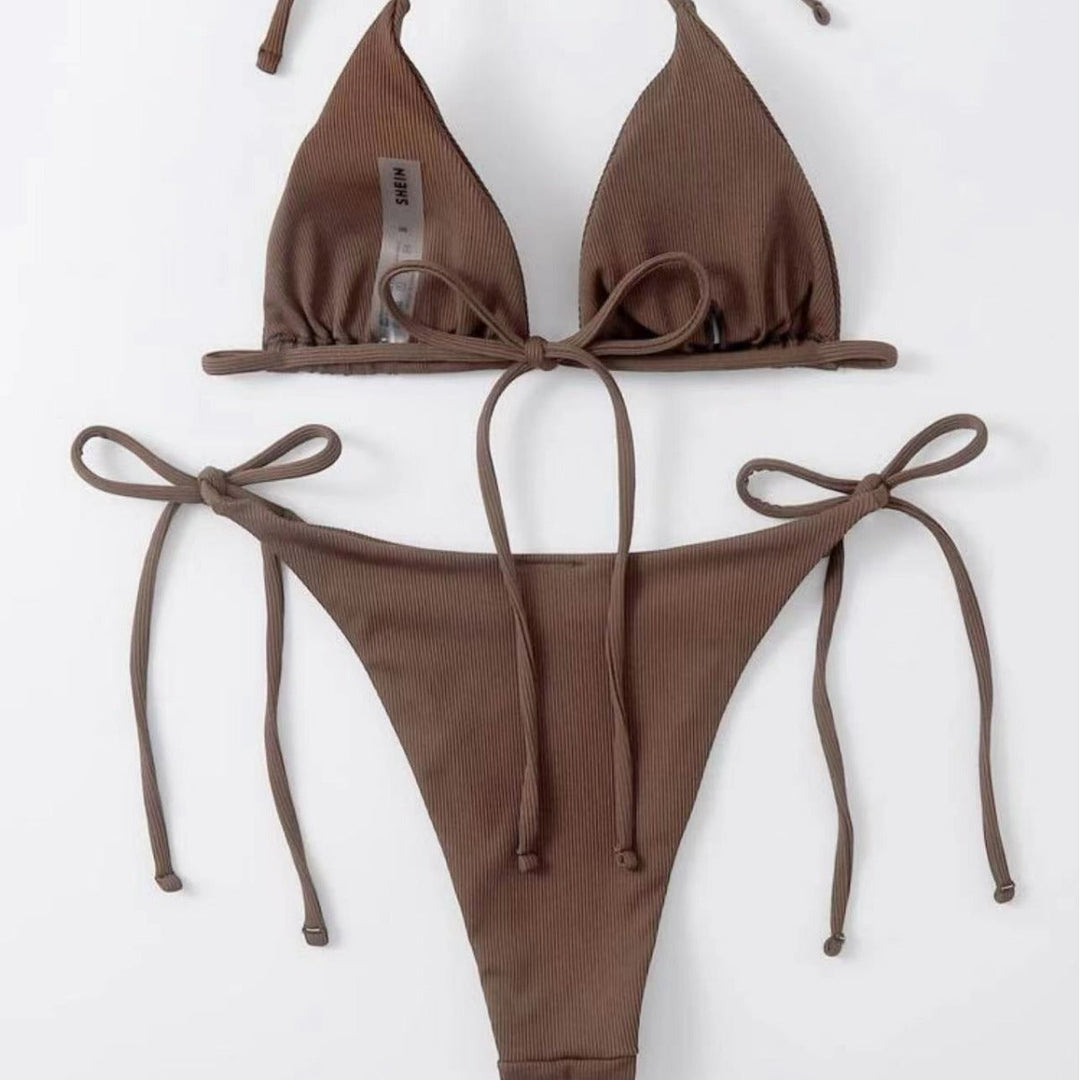 Striped bikini bottoms, part of a flattering tie-front set. Essential women's summer beachwear.