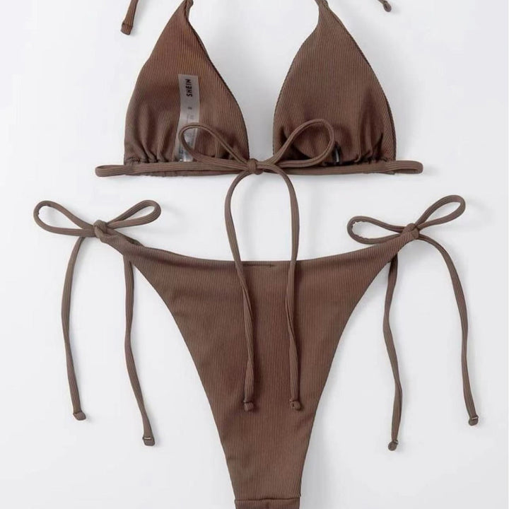 Striped bikini bottoms, part of a flattering tie-front set. Essential women's summer beachwear.