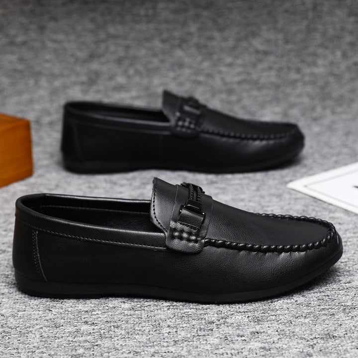 Close-up of men's classic brown slip-on moccasins, highlighting the leather texture & casual style.