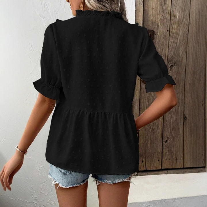 White women's ruffled long-sleeve top, a versatile and comfortable spring blouse for casual or smart-casual styles.