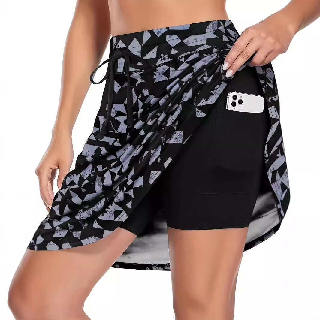 Stylish women's athletic skirt with geometric pattern, built-in compression shorts & pockets. Perfect for tennis & activewear.