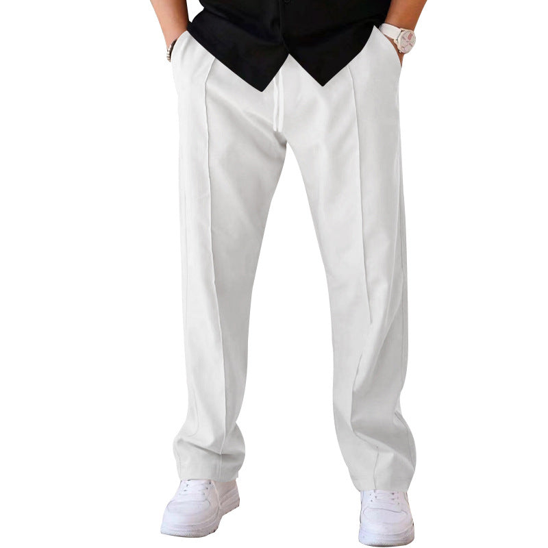 Man in stylish grey sweatpants enjoying outdoor casual activity, blending comfort & fashion.