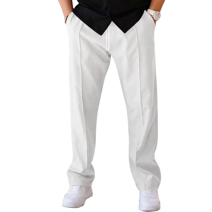 Man in stylish grey sweatpants enjoying outdoor casual activity, blending comfort & fashion.