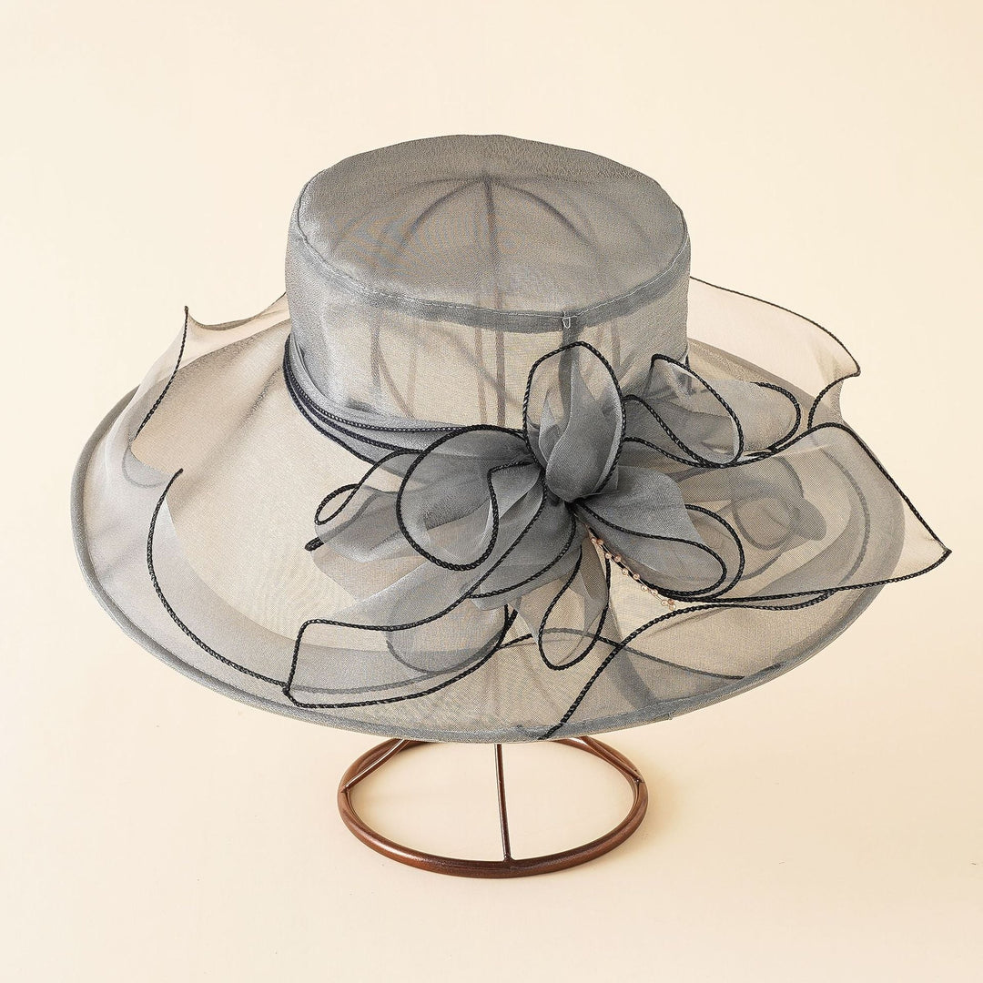 Elegant women's mesh sun hat with a romantic bow, perfect for summer beach or garden parties.