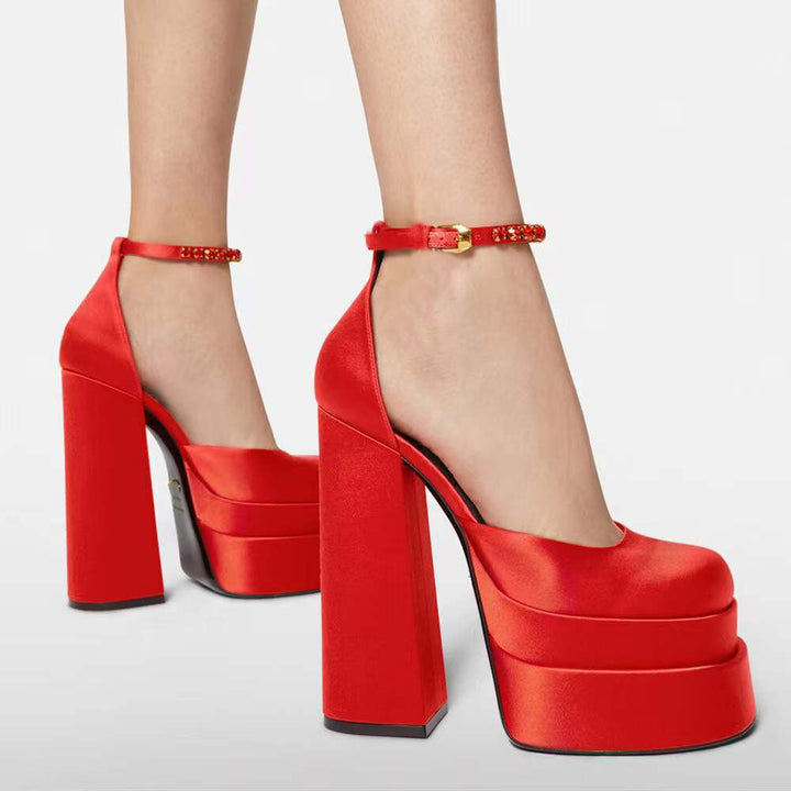 Women's black high heel platform shoes with a secure ankle strap for elegant party wear.