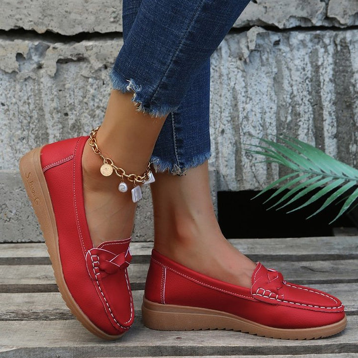 Soft women's driving moccasins, slip-on style with bow applique and reliable non-slip sole.