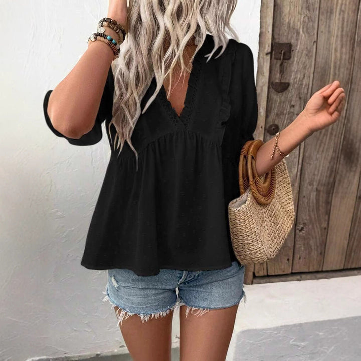 Close-up of elegant ruffled details on a women's long-sleeve blouse, showcasing its unique and versatile design.