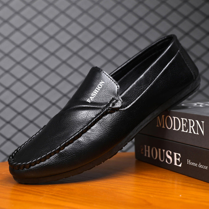 Black men's slip-on moccasins, hand-stitched for all-day comfort, versatile for casual and dress shoes.