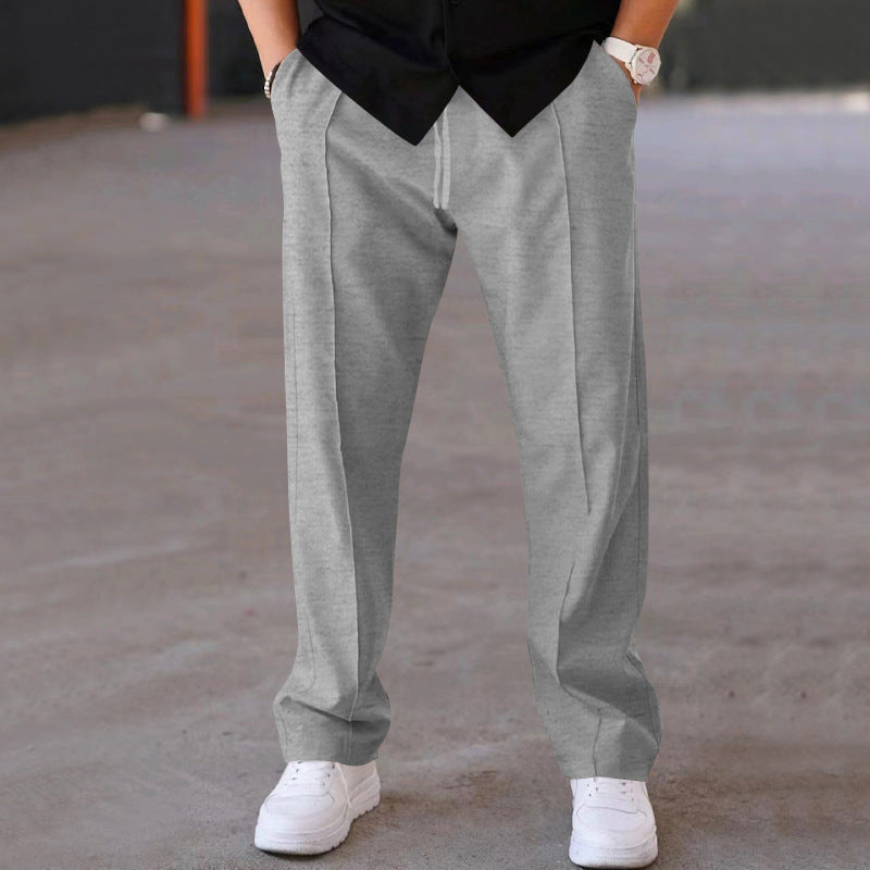 Man in grey relaxed fit sweatpants, demonstrating effortless style & comfort for everyday.