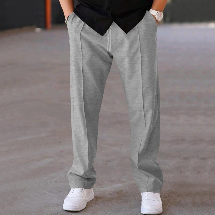 Man in grey relaxed fit sweatpants, demonstrating effortless style & comfort for everyday.