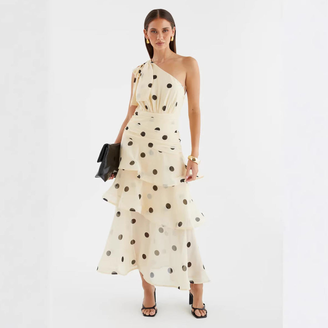 Women's formal polka dot one-shoulder maxi dress with a dramatic voluminous skirt, perfect for parties.