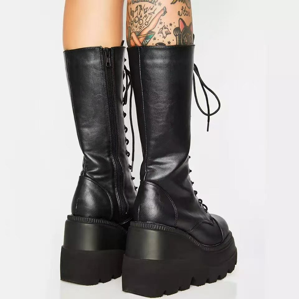 Stylish women's black platform boots with lace-up detail & side zipper. Chunky heel offers comfort & trendy look.