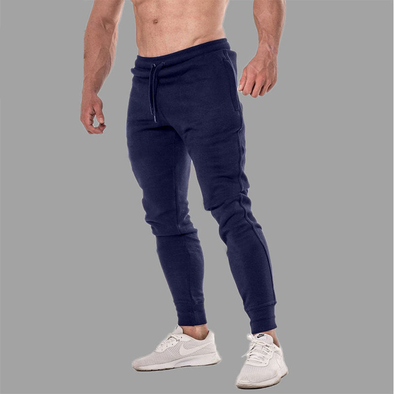 Stack of men's versatile jogging pants in various colors, essential for activewear and men's fashion.