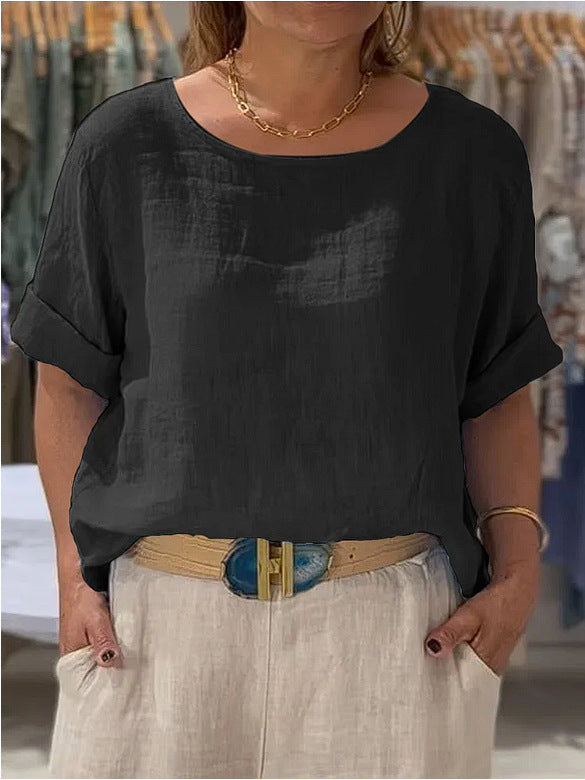 Women's relaxed fit blouse, elegantly rolled sleeves, lightweight fabric. Ideal for spring fashion.