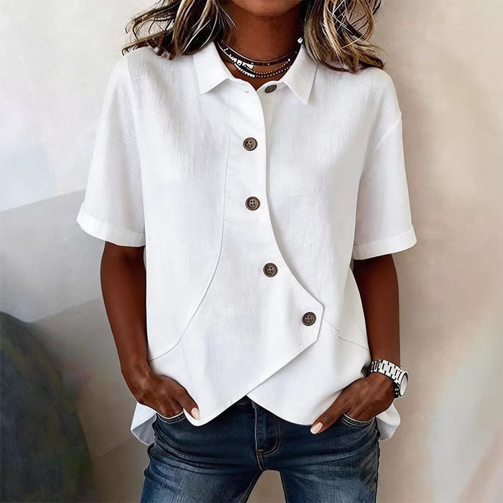 Elegant women's blouse with unique button detail and chic wavy pattern, perfect for spring fashion.
