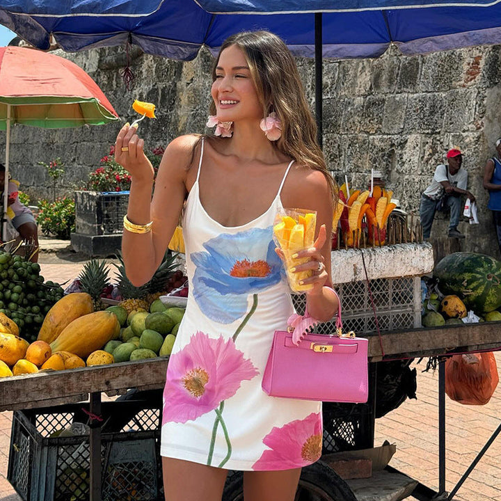 Elegant women's floral mini dress with spaghetti straps, perfect for summer casual wear or vacation.