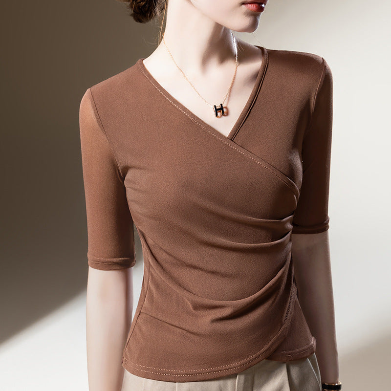 Classic black women's elegant wrap top. V-neck, half sleeves & flattering draped silhouette. Feminine style.