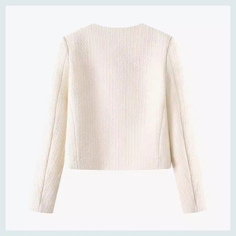Elegant women's short jacket with detailed gold buttons, offering a sophisticated and classic style.