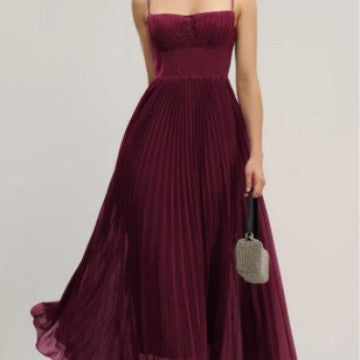 Fashionable women's bustier maxi dress featuring a full pleated skirt. Elegant choice for special occasions & parties.