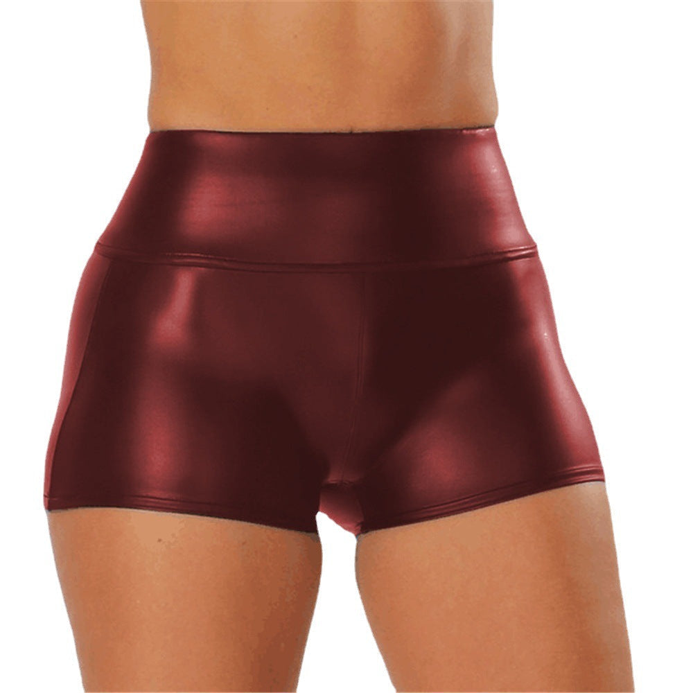 Stylish shiny high-waisted sports shorts for women, ideal for yoga & fitness.